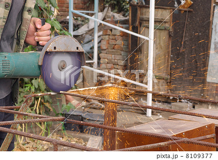 Angle Grinder Metal sawing with flashing sparks handheld electric instrument 8109377