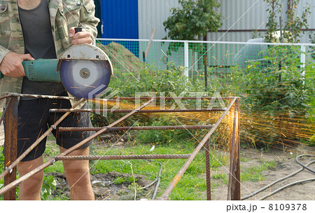 Angle Grinder Metal sawing with flashing sparks handheld electric instrument Angle Grinder Metal sawing with flashing sparks handheld electric instrument 8109378