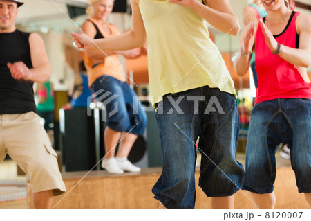 Zumba or Jazzdance - young people dancing in studio Zumba or Jazzdance - young people dancing in studio 8120007
