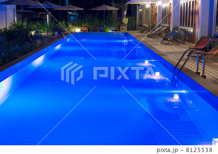 pretty swimming pool in night at a local resort pretty swimming pool in night at a local resort 8125538