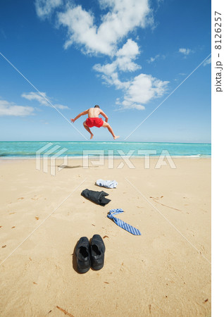 businessman jumping on the beach 8126257
