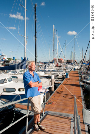 Elderly man in harbor 8134946