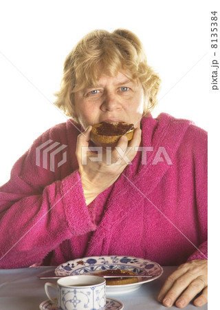 Senior woman is having breakfast 8135384