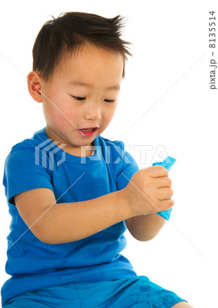 Chinese boy folding a paper boat 8135514
