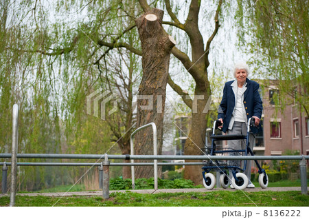 Elderly woman with walker 8136222