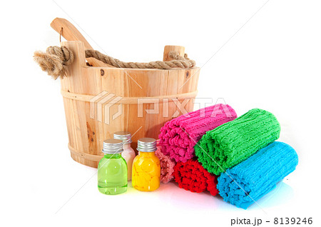 Wooden sauna bucket with colorful towels and soap 8139246