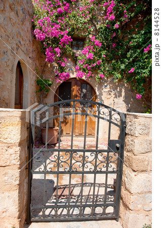 House exterior with pink flowers in Greece 8144528