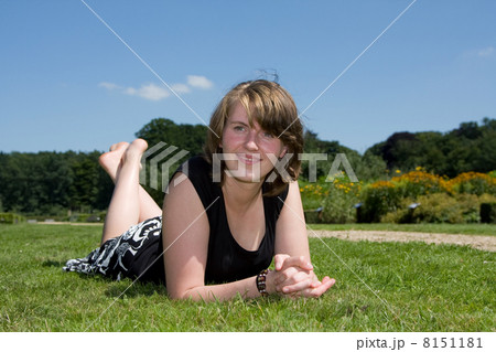Young woman lying in the grass 8151181