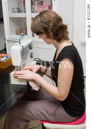 Young woman works at a sewing machine Young woman works at a sewing machine 8151199