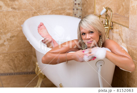 Beautiful tanned girl is taking a luxurious bath Beautiful tanned girl is taking a luxurious bath 8152063