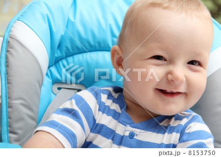 baby boy sitting in highchair 8153750