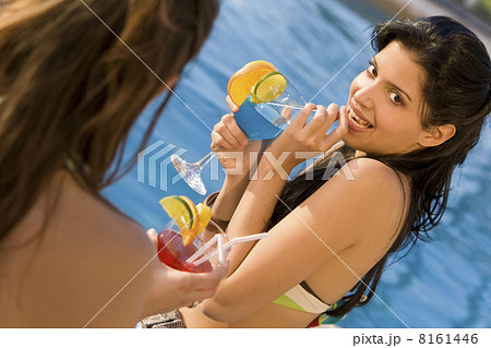 Hispanic Woman Drinking Cocktail By Swimming Pool 8161446