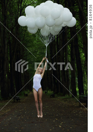 Fantasy. Nostalgic Svelte Woman with Air Balloons on Country Road 8164936