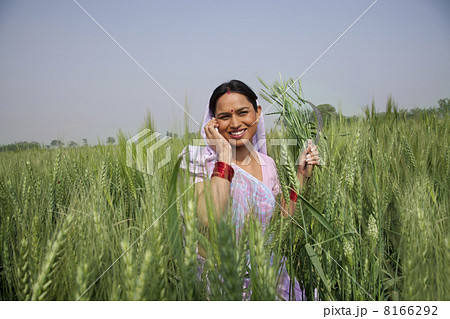 Portrait of an Indian female farm worker talking on phone 8166292