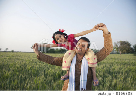 Portrait of a happy father carrying daughter on shoulders 8166308