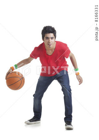 Full length portrait of young boy playing basketball over white background 8166331
