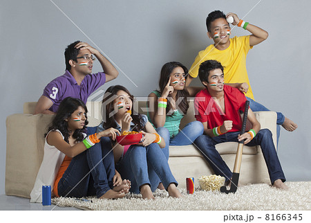 Young friends reacting with disappointment while watching hockey match 8166345