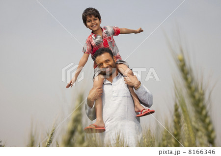 Portrait of a man carrying little boy on shoulders 8166346