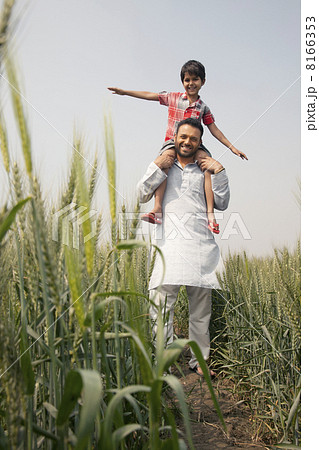 Low angle view of a happy father carrying son on shoulders 8166353