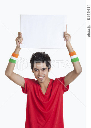 Portrait of young boy in red t-shirt holding a blank placard over white background Portrait of young boy in red t-shirt holding a blank placard over white background 8166414