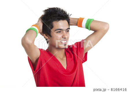 Disappointed young boy looking away with hands behind head over white background 8166416