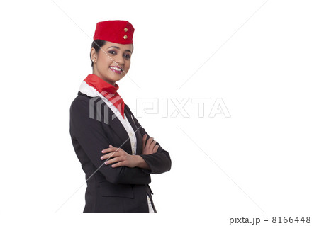 Portrait of an air hostess with arms crossed standing against white background Portrait of an air hostess with arms crossed standing against white background 8166448