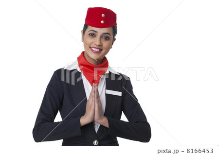 Portrait of young airhostess greeting Namaste isolated over white background Portrait of young airhostess greeting Namaste isolated over white background 8166453