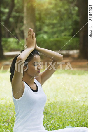 Young woman doing yoga with hands in prayer position 8166605