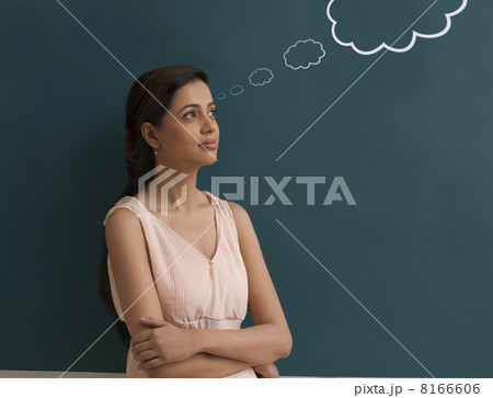 Young female teacher with thought bubble on chalk board 8166606