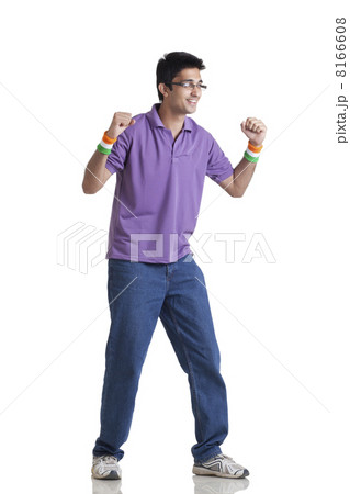 Full length of young man in casual wear looking away with clenched fists over white background 8166608