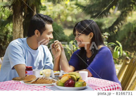 Couple holding hands on breakfast table Couple holding hands on breakfast table 8166731