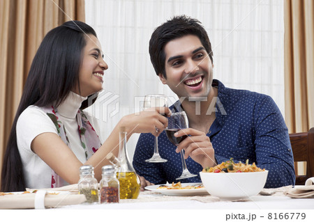 Cheerful young couple enjoying the meal at restaurant Cheerful young couple enjoying the meal at restaurant 8166779
