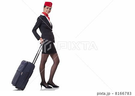 Portrait of a flight attendant with luggage bag isolated over white background Portrait of a flight attendant with luggage bag isolated over white background 8166783