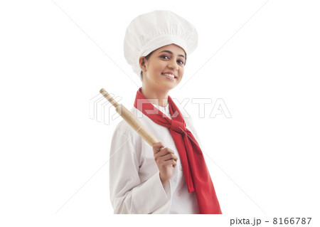 Portrait of young female chef holding rolling pin isolated over white background Portrait of young female chef holding rolling pin isolated over white background 8166787