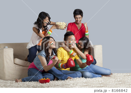 Friends enjoying together while watching a boxing match at home 8166842
