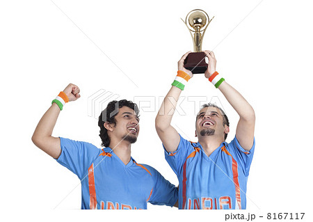 Happy young male friends in jerseys cheering up with winning trophy over white background 8167117