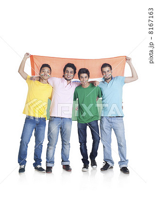 Full length portrait of young male friends in casuals holding Indian flag over white background 8167163