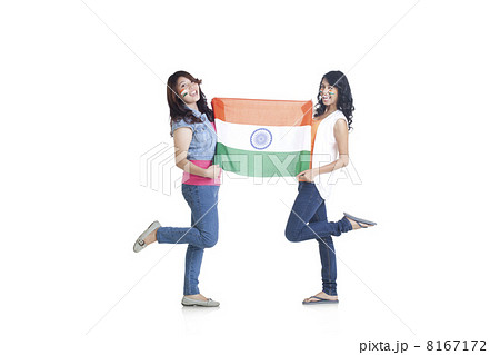 Full length portrait of young women in casuals holding Indian flag over white background 8167172