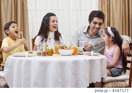 Happy parents and children eating pizza together at restaurant Happy parents and children eating pizza together at restaurant 8167177