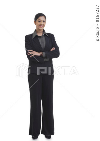 Full length portrait of confident businesswoman with arms crossed standing against white background 8167237