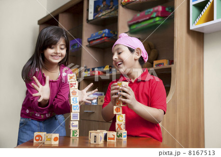 Cute little brother and sister playing with wooden toy blocks 8167513