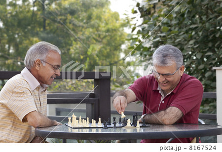 Happy senior men playing chess together 8167524