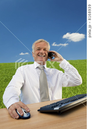 Business Man Talking on Phone in Green Field Office Business Man Talking on Phone in Green Field Office 8168939