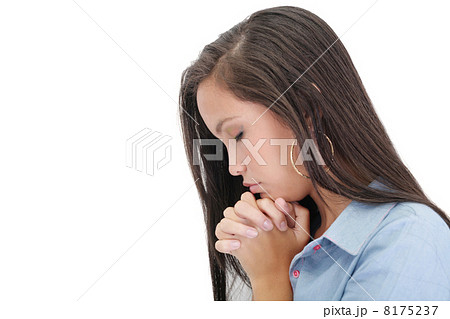 A young woman praying with her hands together on white backgroun 8175237