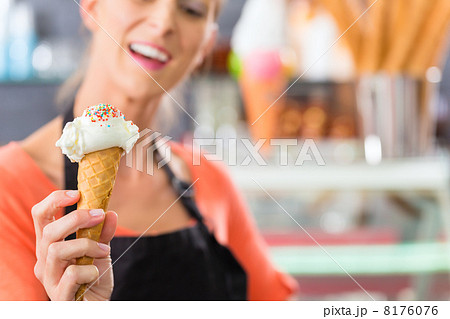 Female seller in Parlor with ice cream cone 8176076