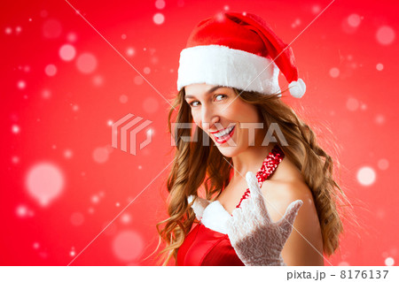 Attractive young woman in Santa Claus costume alluring gesture 8176137