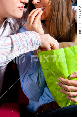 Couple in cinema theater with popcorn 8176521