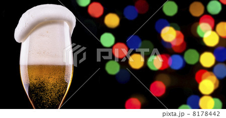 Frosty glass of light beer on party background Frosty glass of light beer on party background 8178442