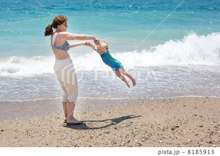 Happy mother and little baby son having fun at beach vacation Happy mother and little baby son having fun at beach vacation 8185913