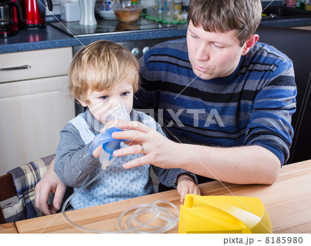 Little boy and his father making inhalation with nebuliser Little boy and his father making inhalation with nebuliser 8185980